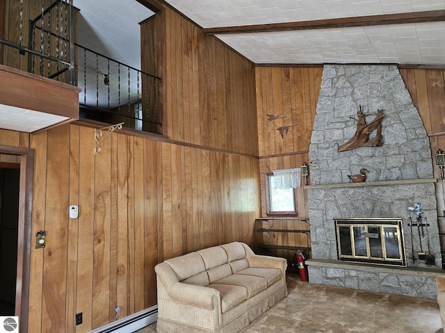 4451 Bissonette Rd, Oscoda, MI 48750 - carpeted living area with wood walls and a stone fireplace