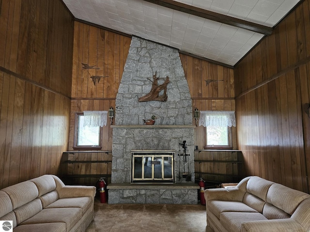 4451 Bissonette Rd, Oscoda, MI 48750 - living room with wood walls, carpet floors, a stone fireplace, and lofted ceiling