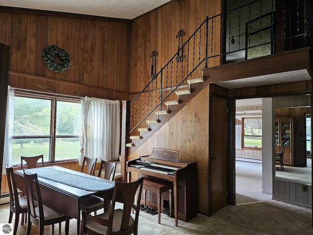 4451 Bissonette Rd, Oscoda, MI 48750 - carpeted dining room with wood walls and stairs
