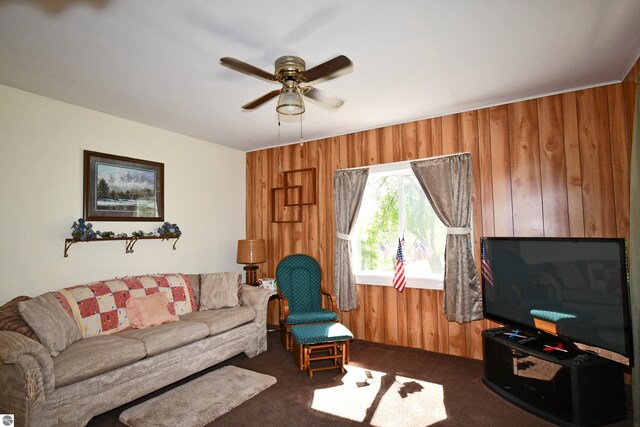 4327 S M-65, Glennie, MI 48737 - living room with wood walls, a ceiling fan, and dark colored carpet