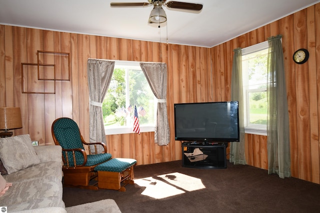 4327 S M-65, Glennie, MI 48737 - living area featuring wood walls, plenty of natural light, carpet flooring, ceiling fan, and crown molding