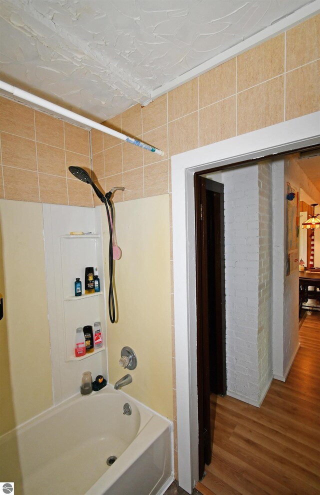 4327 S M-65, Glennie, MI 48737 - bathroom featuring shower / washtub combination and wood finished floors