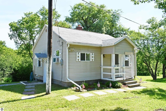 4327 S M-65, Glennie, MI 48737 - bungalow-style house featuring a chimney, a front yard, and roof with shingles
