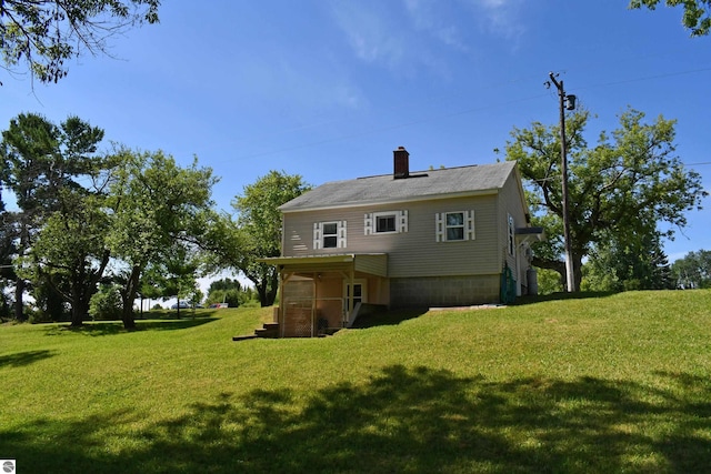 4327 S M-65, Glennie, MI 48737 - back of house with a yard and a chimney