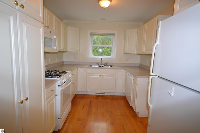 1433 Elk Run, Traverse City, MI 49696 - kitchen featuring white appliances, a sink, light wood-type flooring, and light countertops