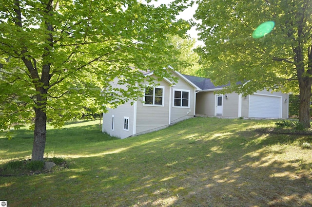 1433 Elk Run, Traverse City, MI 49696 - view of grassy yard featuring an attached garage