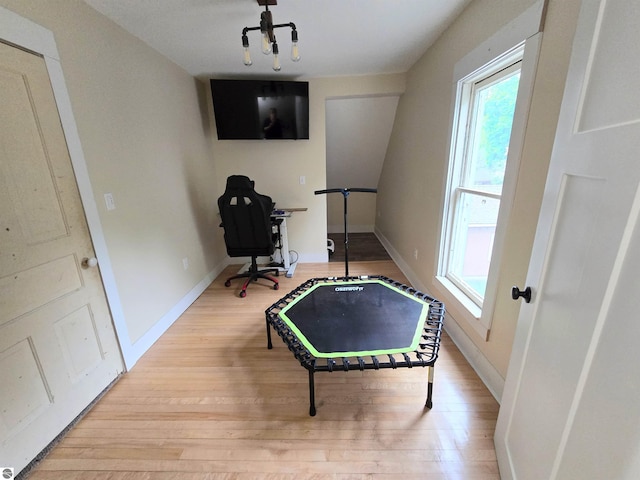 820 Wallace St, Cadillac, MI 49601 - game room with wood finished floors, baseboards, and a chandelier