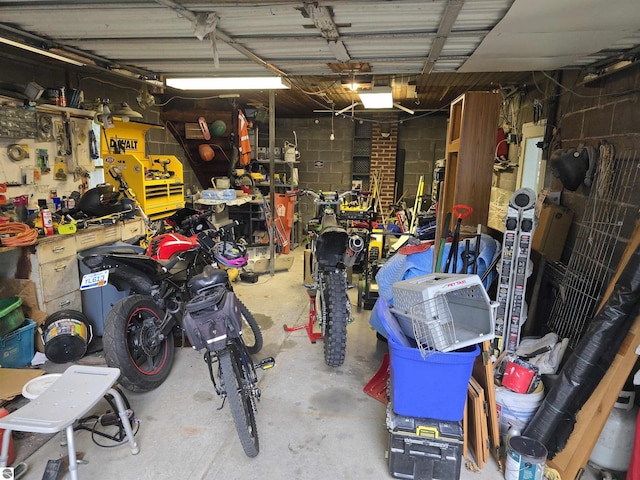 820 Wallace St, Cadillac, MI 49601 - garage with a workshop area, a garage door opener, and concrete block wall