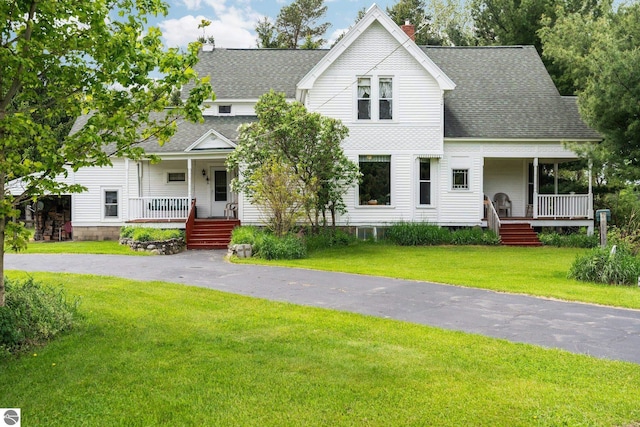 9889 Ramsay Rd, Buckley, MI 49620 - view of front of house featuring covered porch, a shingled roof, a front lawn, and a chimney