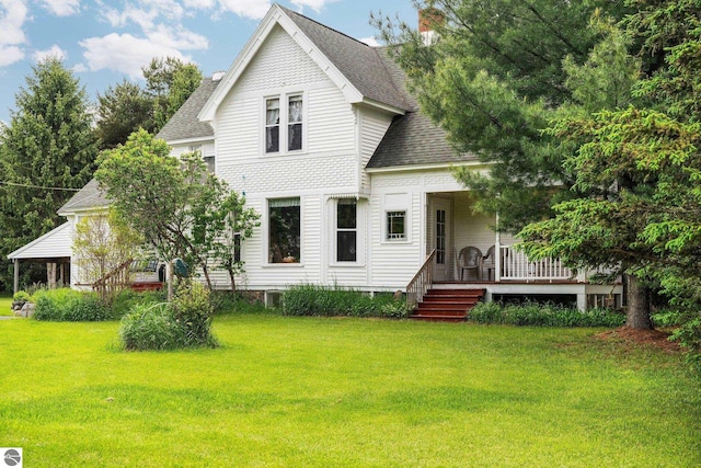 9889 Ramsay Rd, Buckley, MI 49620 - victorian house with a shingled roof and a front lawn