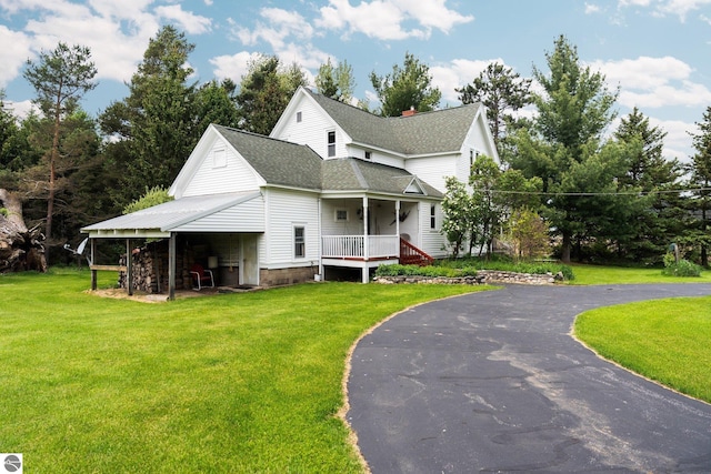 9889 Ramsay Rd, Buckley, MI 49620 - view of front facade featuring a front lawn, roof with shingles, and asphalt driveway