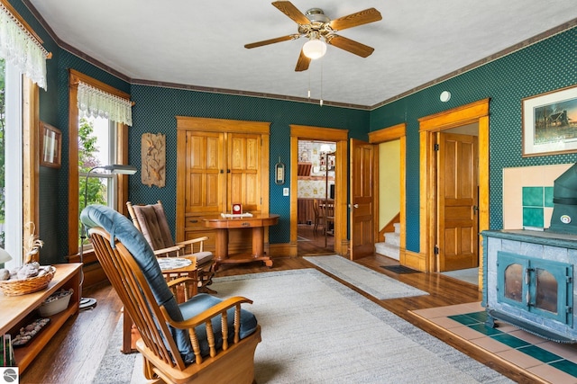 9889 Ramsay Rd, Buckley, MI 49620 - living room with wood finished floors, ornamental molding, ceiling fan, stairs, and wallpapered walls