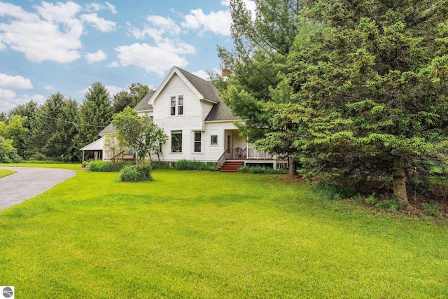 9889 Ramsay Rd, Buckley, MI 49620 - view of front facade with a front lawn, a deck, and a shingled roof