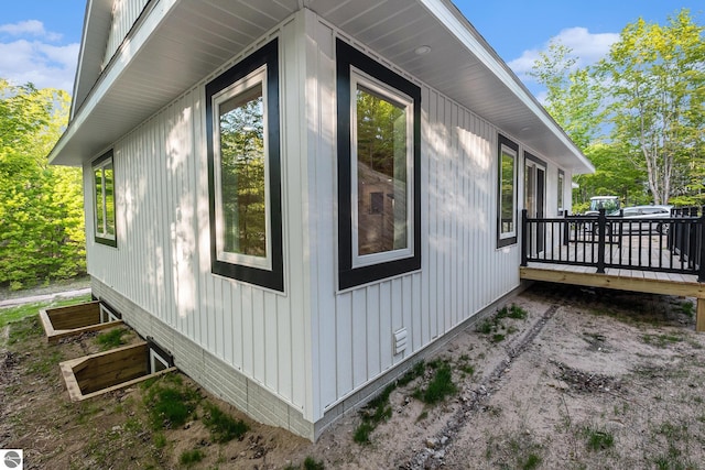 4144 S Sugar Loaf Mountain Rd, Cedar, MI 49621 - view of side of home featuring a wooden deck and board and batten siding