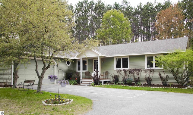 10226 Deerpath N, Traverse City, MI 49685 - ranch-style house featuring an attached garage, covered porch, and roof with shingles