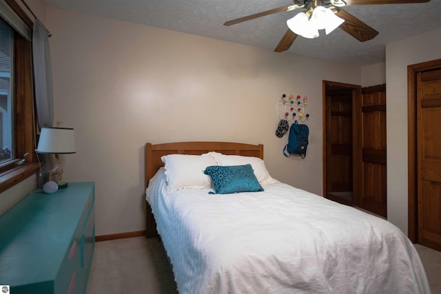 10226 Deerpath N, Traverse City, MI 49685 - bedroom with light carpet, a ceiling fan, a textured ceiling, and baseboards