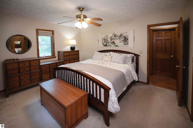 10226 Deerpath N, Traverse City, MI 49685 - bedroom with light colored carpet, a textured ceiling, a ceiling fan, and baseboards