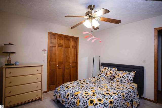 10226 Deerpath N, Traverse City, MI 49685 - bedroom with carpet flooring, a closet, ceiling fan, and a textured ceiling