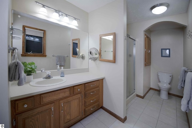 10226 Deerpath N, Traverse City, MI 49685 - full bathroom with vanity, toilet, a stall shower, and tile patterned flooring