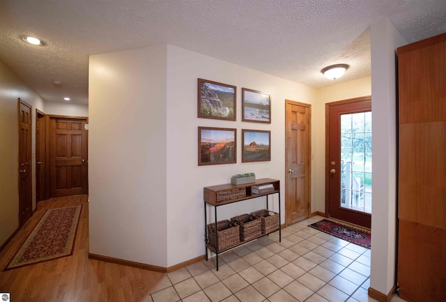 10226 Deerpath N, Traverse City, MI 49685 - foyer entrance with a textured ceiling, recessed lighting, and baseboards