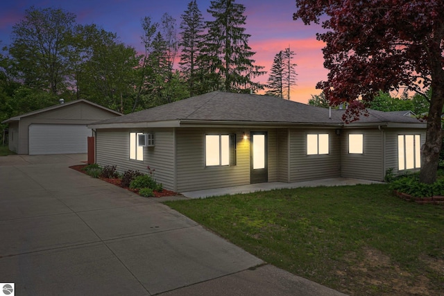217 Winona Pl, Cadillac, MI 49601 - single story home featuring a detached garage, an outdoor structure, a front yard, and a shingled roof