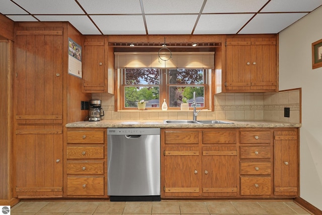 217 Winona Pl, Cadillac, MI 49601 - kitchen featuring dishwasher, a sink, a paneled ceiling, backsplash, and brown cabinetry