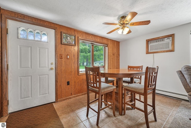 217 Winona Pl, Cadillac, MI 49601 - dining area with a baseboard heating unit, an AC wall unit, ceiling fan, a textured ceiling, and wood walls