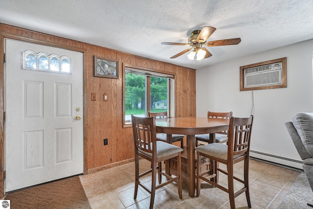 217 Winona Pl, Cadillac, MI 49601 - dining space featuring baseboard heating, ceiling fan, a textured ceiling, a wall mounted AC, and wooden walls
