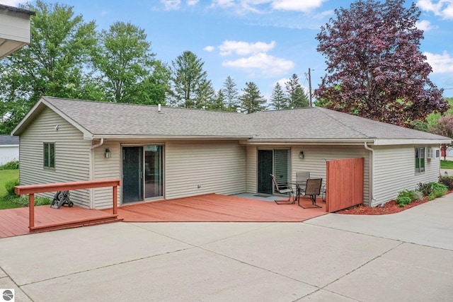 217 Winona Pl, Cadillac, MI 49601 - back of house with a deck, a shingled roof, and a patio