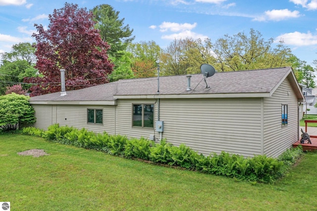 217 Winona Pl, Cadillac, MI 49601 - back of property with a yard and roof with shingles