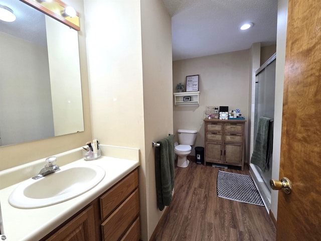 902 S Crapo St, Mount Pleasant, MI 48858 - full bath with an enclosed shower, wood finished floors, vanity, toilet, and a textured ceiling