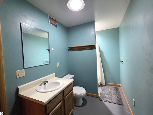 902 S Crapo St, Mount Pleasant, MI 48858 - bathroom featuring toilet, vanity, baseboards, and finished concrete flooring