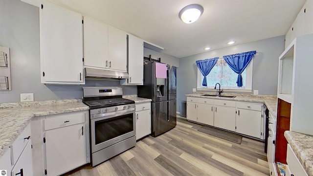 3145 S Concourse Dr, Mount Pleasant, MI 48858 - kitchen featuring stainless steel gas range, under cabinet range hood, a sink, refrigerator with ice dispenser, and white cabinetry