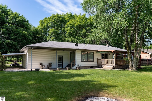 3145 S Concourse Dr, Mount Pleasant, MI 48858 - back of house with a lawn, an attached carport, and entry steps