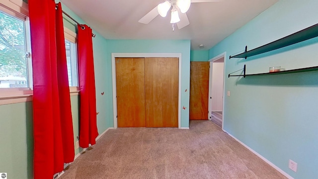 3145 S Concourse Dr, Mount Pleasant, MI 48858 - unfurnished bedroom featuring carpet, a closet, ceiling fan, and baseboards