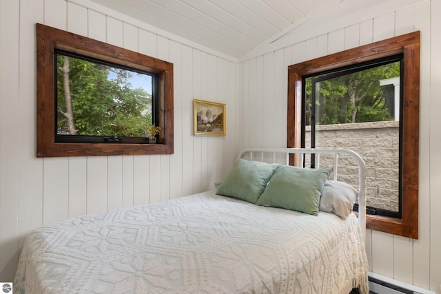 8489 S Glen Lake Rd, Glen Arbor, MI 49636 - bedroom with baseboard heating, vaulted ceiling, and wooden walls