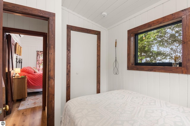8489 S Glen Lake Rd, Glen Arbor, MI 49636 - bedroom with wood finished floors, lofted ceiling, and wood walls
