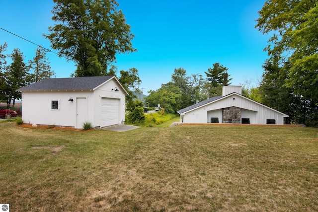 8489 S Glen Lake Rd, Glen Arbor, MI 49636 - view of green lawn featuring a garage and an outdoor structure