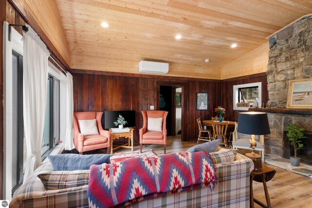 8489 S Glen Lake Rd, Glen Arbor, MI 49636 - living room with wooden ceiling, a wall mounted air conditioner, vaulted ceiling, wood finished floors, and wooden walls