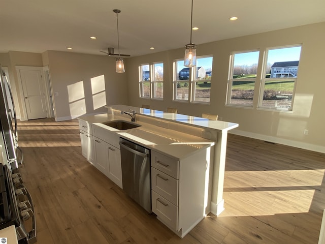 7559 E Meadows Dr Unit 52, Traverse City, MI 49621 - kitchen with appliances with stainless steel finishes, a sink, hardwood / wood-style flooring, baseboards, and recessed lighting