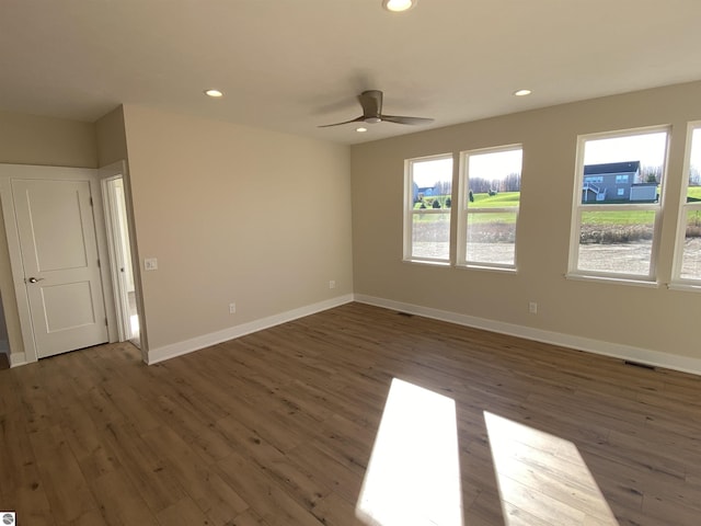 7559 E Meadows Dr Unit 52, Traverse City, MI 49621 - empty room with wood finished floors, a ceiling fan, recessed lighting, baseboards, and a water view