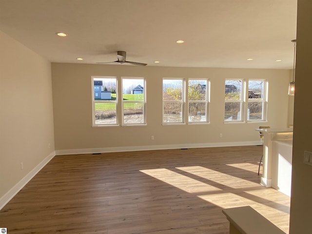 7559 E Meadows Dr Unit 52, Traverse City, MI 49621 - unfurnished room featuring recessed lighting, wood finished floors, a ceiling fan, and baseboards