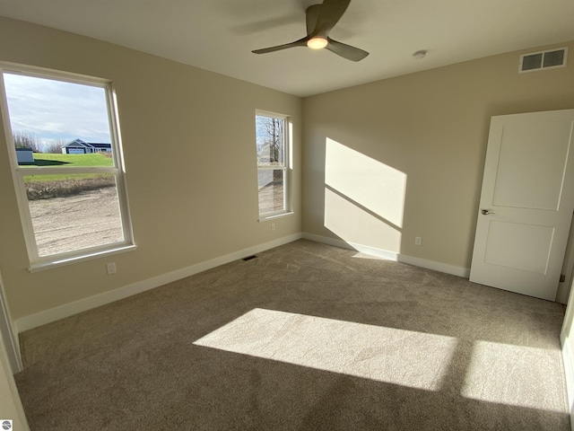 7559 E Meadows Dr Unit 52, Traverse City, MI 49621 - empty room featuring carpet flooring, baseboards, and a ceiling fan