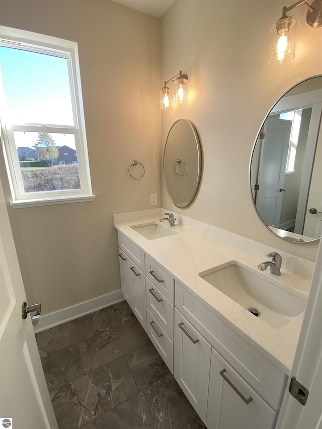 7559 E Meadows Dr Unit 52, Traverse City, MI 49621 - full bath with marble look tile flooring, healthy amount of natural light, double vanity, and baseboards
