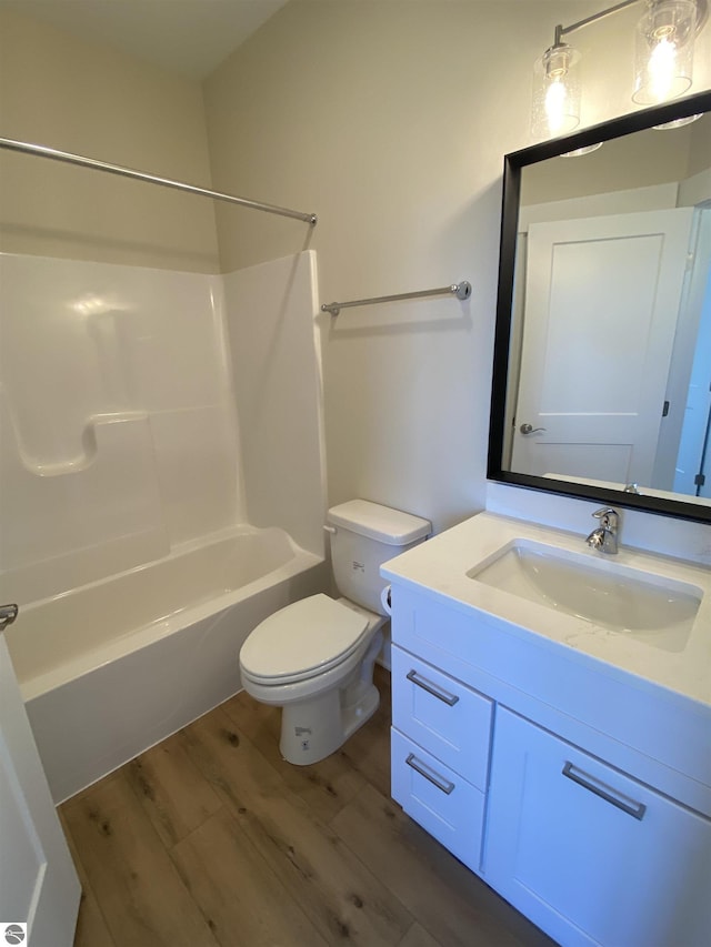 7559 E Meadows Dr Unit 52, Traverse City, MI 49621 - full bath with wood finished floors, vanity, bathtub / shower combination, and toilet