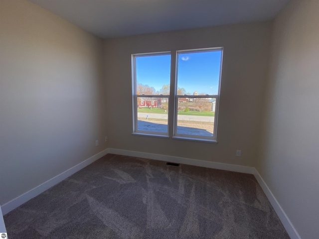 7559 E Meadows Dr Unit 52, Traverse City, MI 49621 - carpeted empty room featuring baseboards