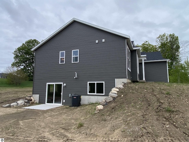 7559 E Meadows Dr Unit 52, Traverse City, MI 49621 - back of house with central AC and a patio area