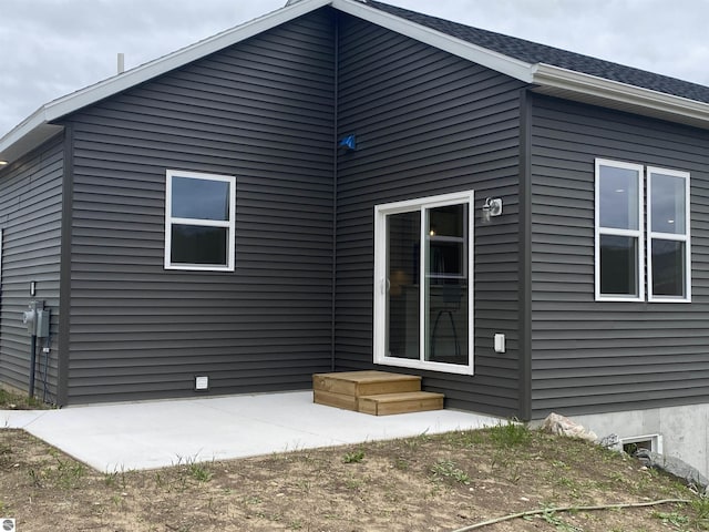 7559 E Meadows Dr Unit 52, Traverse City, MI 49621 - rear view of house with a patio area