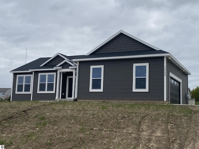 7559 E Meadows Dr Unit 52, Traverse City, MI 49621 - view of front of home featuring a shingled roof