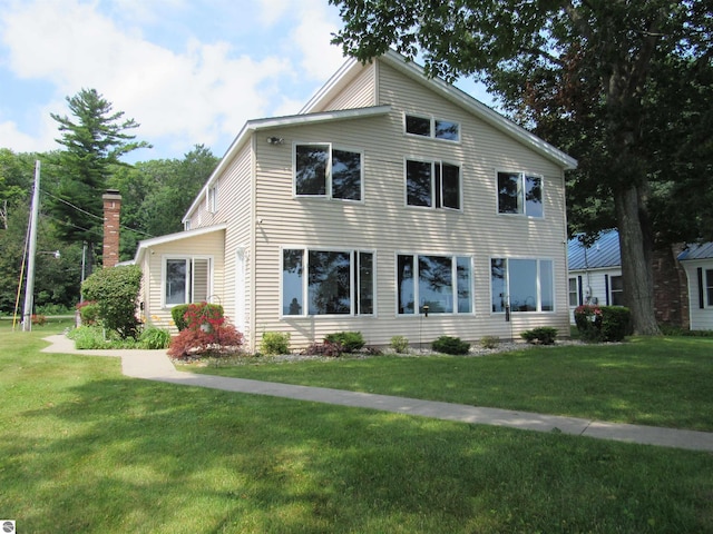 2011 Douglas Dr, Tawas City, MI 48763 - view of front facade featuring a front yard